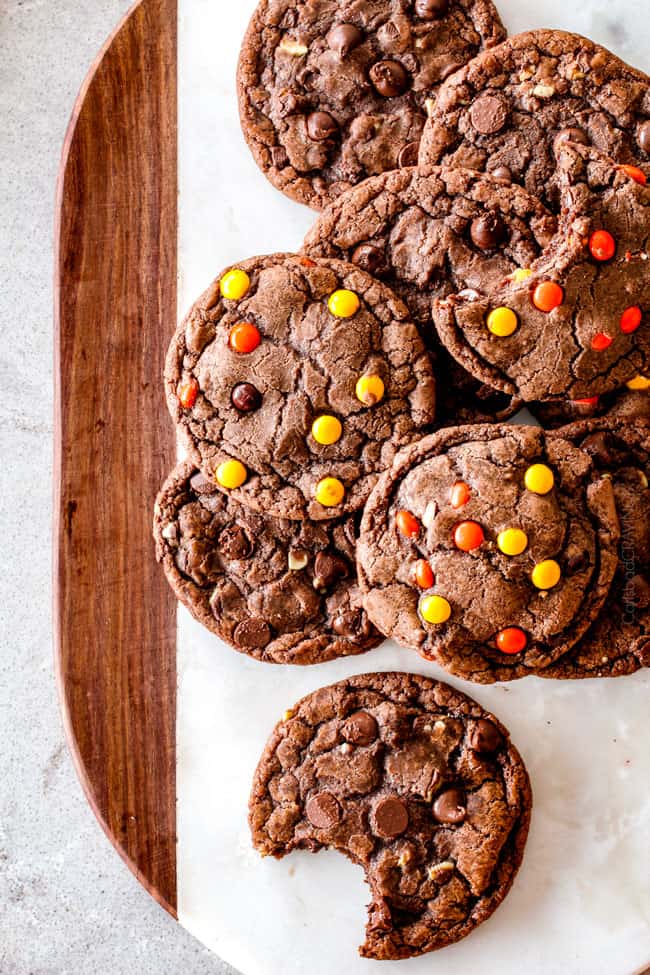 These Super soft and chewy Nutella Cookies are my absolute favorite chocolate cookie with a whole cup of Nutella mixed right into the batter! Mix in anything you want from chocolate chips to, Reese's pieces to Andes mints for the perfect Christmas cookie! top view of nutella cookies wit chocolate chips