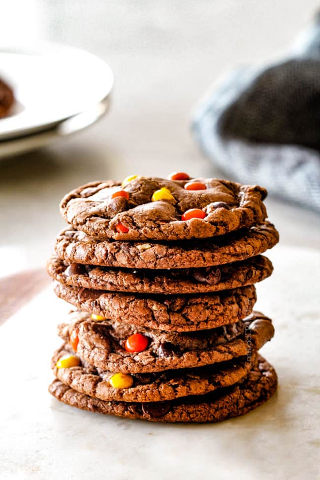 These Super soft and chewy Nutella Cookies are my absolute favorite chocolate cookie with a whole cup of Nutella mixed right into the batter! Mix in anything you want from chocolate chips to, Reese's pieces to Andes mints for the perfect Christmas cookie! a stack of nutella cookies on a white marble cutting board