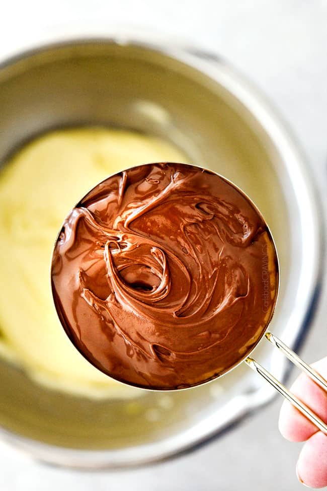 These Super soft and chewy Nutella Cookies are my absolute favorite chocolate cookie with a whole cup of Nutella mixed right into the batter! Mix in anything you want from chocolate chips to, Reese's pieces to Andes mints for the perfect Christmas cookie! showing how to make nutella cookies by mixing nutella into the cookie batter