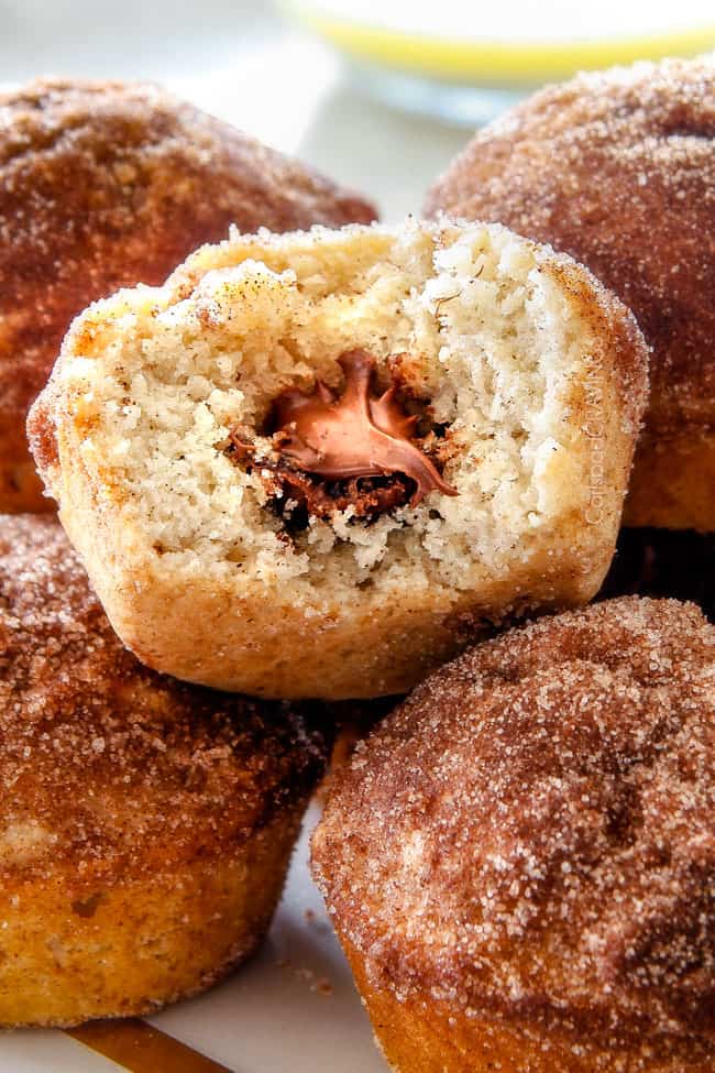 Close up of a Nutella Stuffed Snickerdoodle Muffins with a bite.