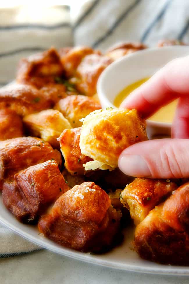 a hand pulling a piece of best monkey bread from scratch apart