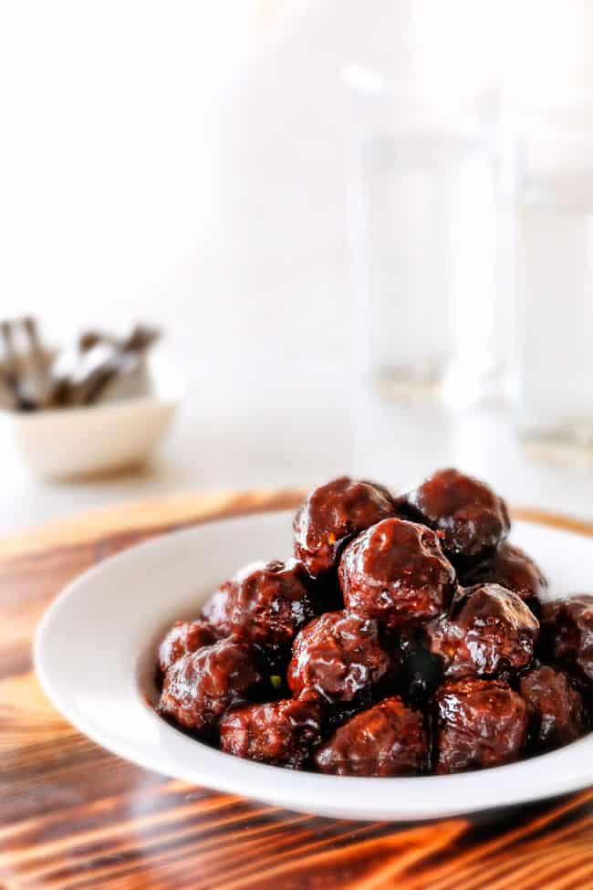 Tender juicy, sweet and spicy Slow cooker Korean Meatballs simmered in the most tantalizing sweet heat sauce that everyone goes crazy for! Perfect appetizer or delicious, easy meal with rice! far away shot of a plate of Korean Meatballs soaked in korean BBQ Sauce