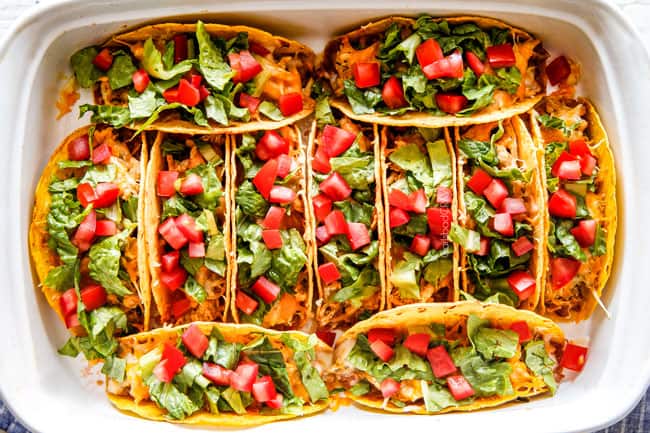 Ranch Chicken Tacos piled with refried beans, cheese tomatoes and lettuce.