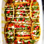 EASY Baked Fiesta Ranch Chicken Tacos piled with refried beans, cheese and the most amazing slow cooker chicken making assembly a snap! My family begs for these tacos weekly! And don't skip the Tomatillo Avocado Ranch - its to die for!