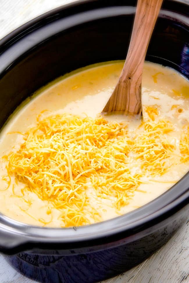 This Skinny Slow Cooker Potato Soup is unbelievably creamy, super flavorful and absolutely the best I've ever tried! and its super easy in the crock pot! showing how to make crockpot potato soup by adding cheese to soup in slow cooker