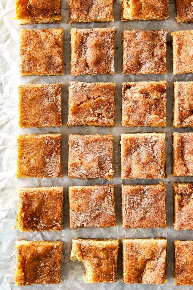 Incredibly EASY, thick, soft and chewy, buttery Snickerdoodle Cookie Bars taste just like the cookie but so much easier and less time consuming! The cinnamon and sugar crackle top is to die for! showing how to make thick snickerdoodle bars by chopping into squares