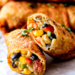 CRISPY Southwest Egg Rolls loaded with Mexican spiced chicken, beans, tomatoes, rice, avocado and cheese! These eggrolls are unreal! So much flavor and texture! And don't skip the Cilantro Lime Ranch Dip - its heaven!