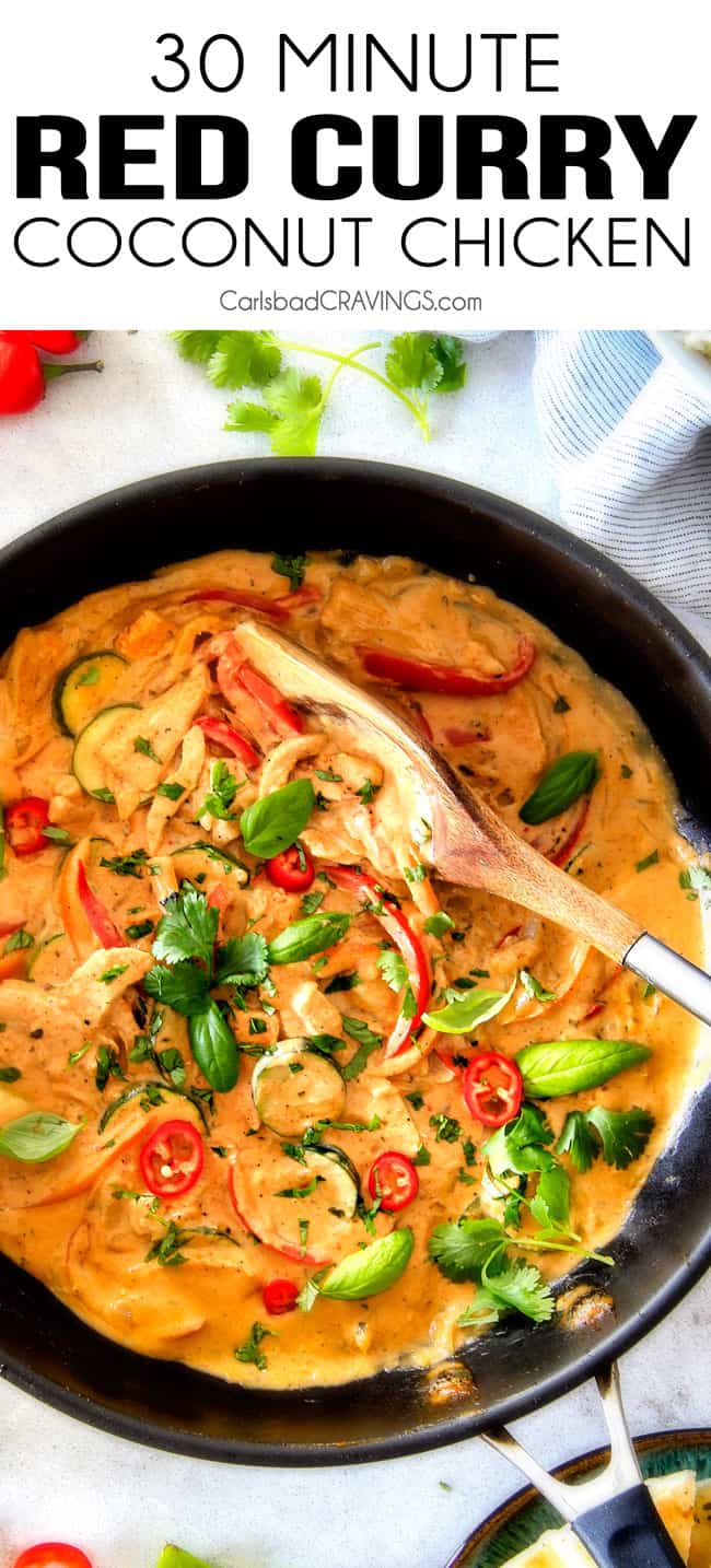 Thai Red Curry Chicken in a black sauce pan with wood serving spoon.