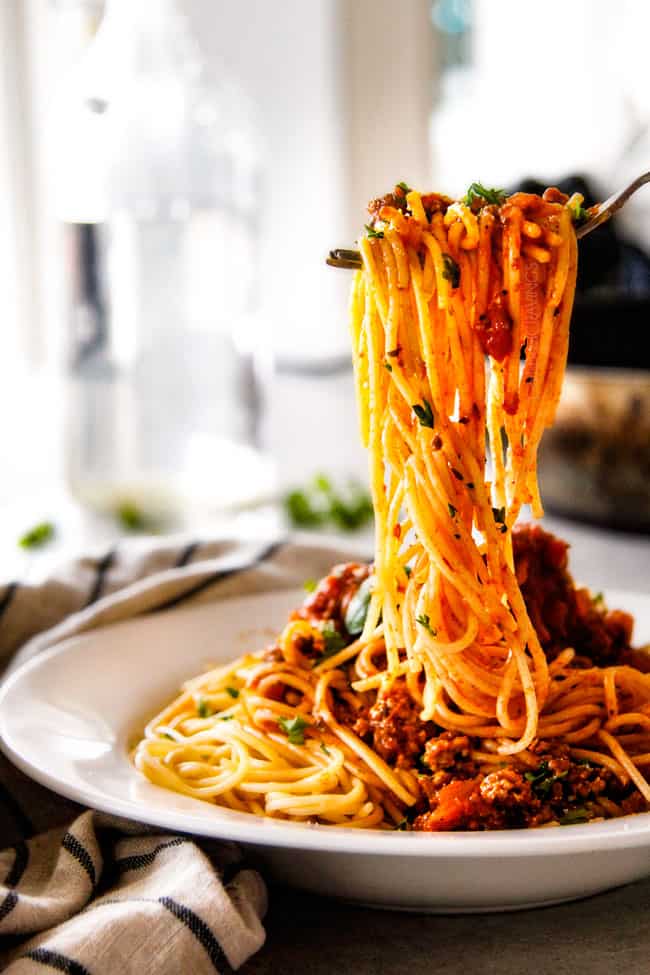 Quick and easy Weeknight Spaghetti Bolognese bursting with flavor on your table in under 30 minutes but tastes like its been simmering all day! We make this recipe more than ANY OTHER RECIPE!