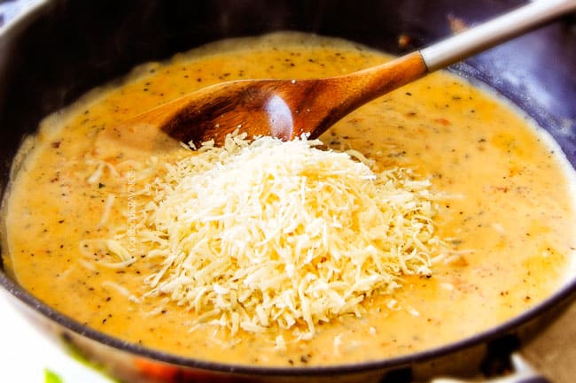 Showing how to make Garlic Mozzarella Margherita Pasta by adding Parmesan cheese.