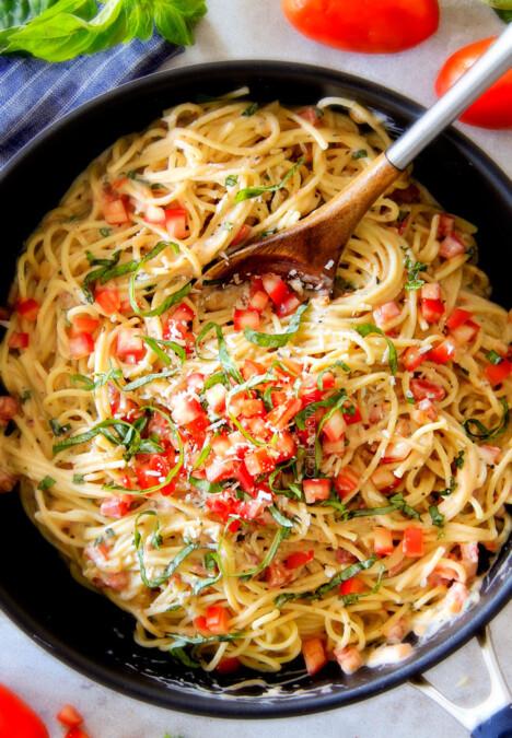 20 Minute LIGHTENED UP Margherita Pasta bursting with fresh tomatoes and basil in a garlic, mozzarella Parmesan sauce! your favorite Margherita pizza in creamy pasta form!