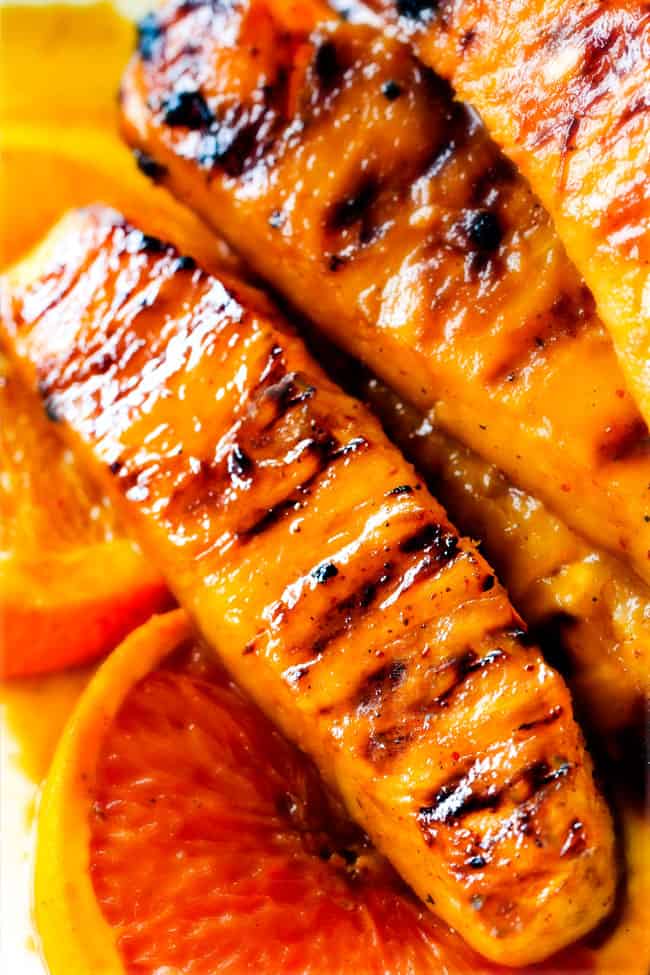 the BEST Caramelized Grilled Pineapple smothered with the moist irresistible buttery, sweet, tangy Brown Sugar Orange Glaze! You will never want to eat pineapple any other way again! Serve it as an easy appetizer, side or even dessert all summer long! up close of spicy grilled pineapple