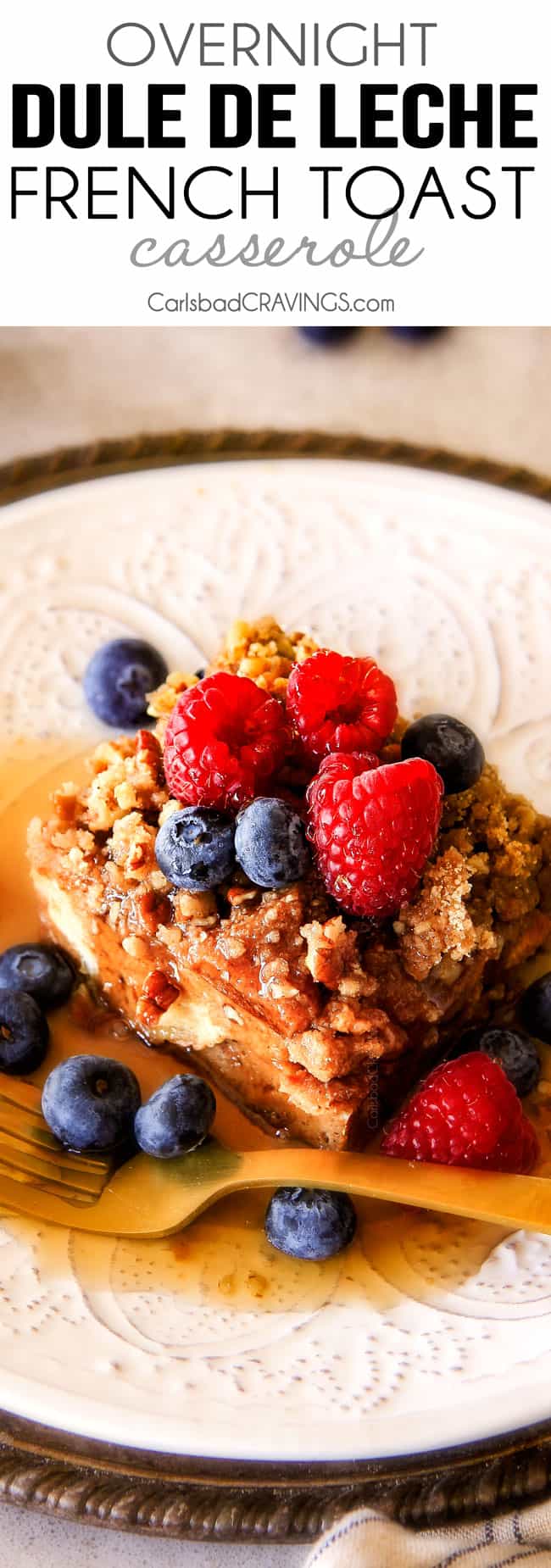 Easy Overnight Dulce de Leche French Toast Casserole infused with wonderfully sweet caramel-like dulce de leche is decadently delicious and all prepared in advance making it ideal for busy or special occasion breakfast. And don't skip the Brown Sugar Pecan Topping - its out of this world! Easy Overnight French Toast Casserole on a white plate with berries