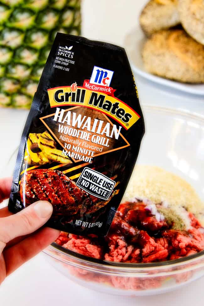 Amazingly juicy Hawaiian Burgers BURSTING with flavor, smothered in Havarti cheese, more Hawaiian Sauce and topped with caramelized pineapple. This might be the best burger. EVER! showing how to make Hawaiian Burgers by adding the meat and seasonings to a glass bowl