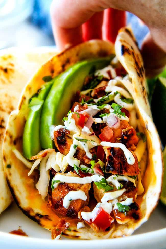 These are ADDICTINGLY DELICIOUS! Honey Chipotle Chicken Tacos stuffed with wonderfully juicy, flavor packed Honey Chipotle Bacon Chicken (yes BACON chicken!), piled with crispy BLT Slaw and creamified with Cilantro Lime Crema!