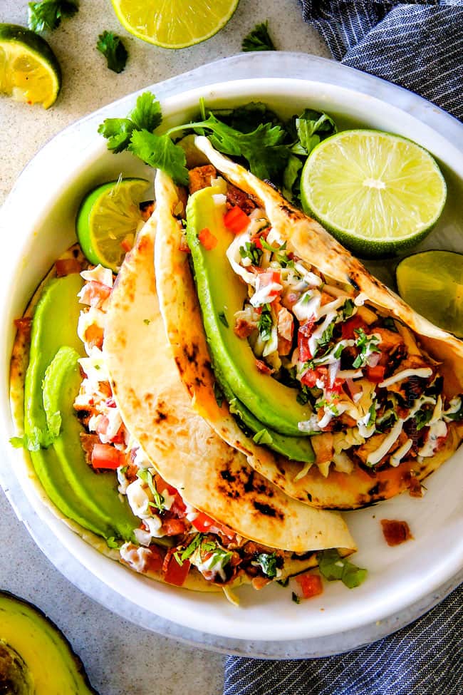 These are ADDICTINGLY DELICIOUS! Honey Chipotle Chicken Tacos stuffed with wonderfully juicy, flavor packed Honey Chipotle Bacon Chicken (yes BACON chicken!), piled with crispy BLT Slaw and creamified with Cilantro Lime Crema!
