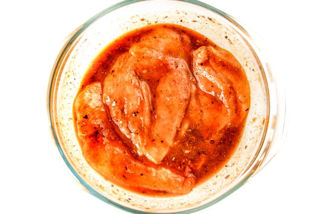 showing how to make chipotle tacos by marinating chicken