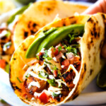 These are ADDICTINGLY DELICIOUS!  Honey Chipotle Chicken Tacos stuffed with wonderfully juicy, flavor packed Honey Chipotle Bacon Chicken (yes BACON chicken!), piled with crispy BLT Slaw and creamified with Cilantro Lime Crema!  