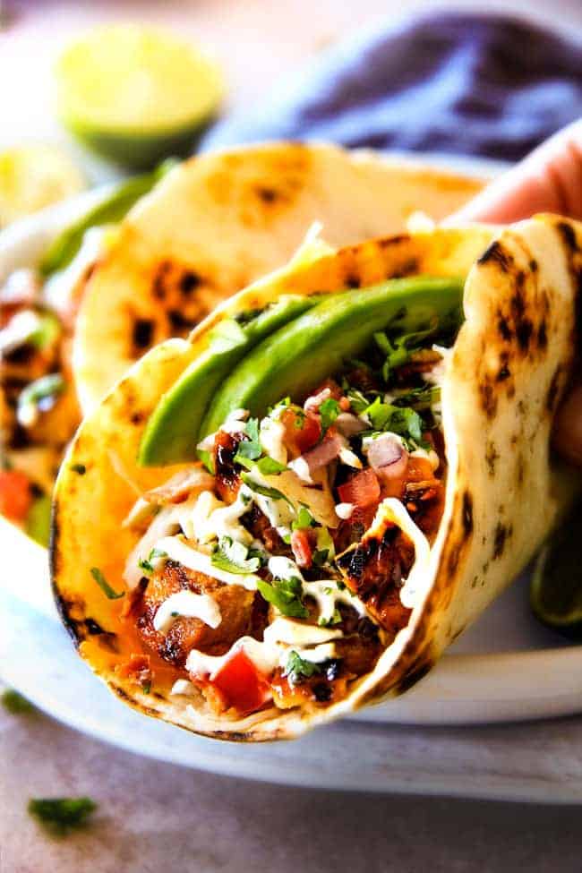 These are ADDICTINGLY DELICIOUS! Honey Chipotle Chicken Tacos stuffed with wonderfully juicy, flavor packed Honey Chipotle Bacon Chicken (yes BACON chicken!), piled with crispy BLT Slaw and creamified with Cilantro Lime Crema!