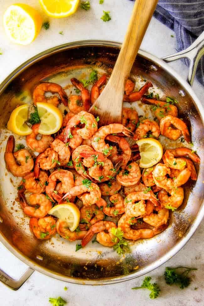 quick and easy Old Bay Shrimp (Grill or Stove top) is so juicy and flavorful and the homemade Cocktail Sauce is amazing! Serve it as an appetizer or add some sides and call it dinner! top view of easy Old Bay Shrimp in a large stainless steel skillet