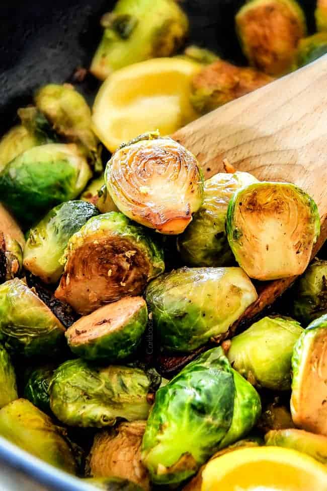 These nutty, caramelized 15 Minute Brussels Sprouts sauteed with garlic, butter and lemon are one of my favorite sides ever and I love the steaming trick for even cooking! up close of easy Sautéed Brussels Sprouts in a skillet