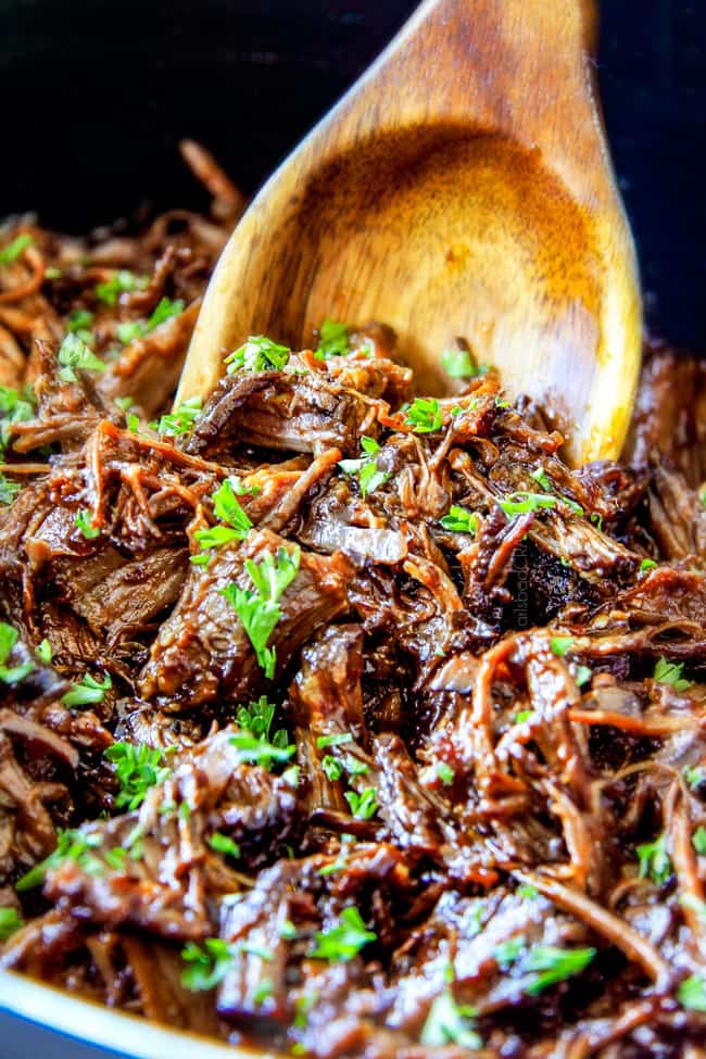 I am obsessed with this sweet and tangy, savory Slow Cooker Honey Balsamic Beef!!! It's fall apart tender, crazy juicy, packed with flavor and smothered in the most AMAZING honey balsamic sauce! perfect for sandwiches or stand alone delicious with rice and potatoes! up close of slow cooker roast beef for sandwiches