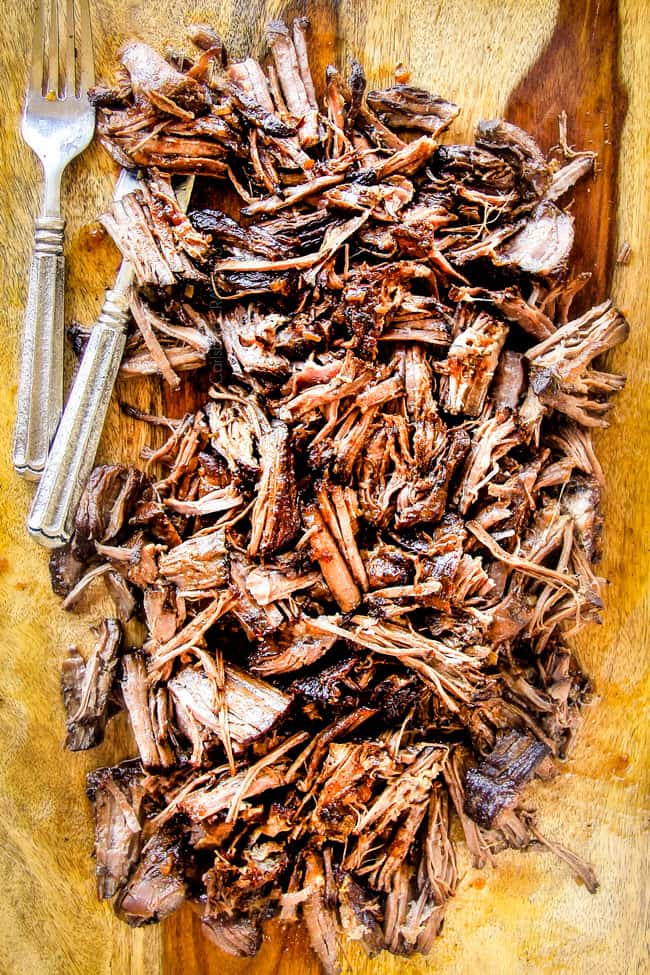 I am obsessed with this sweet and tangy, savory Slow Cooker Honey Balsamic Beef!!! It's fall apart tender, crazy juicy, packed with flavor and smothered in the most AMAZING honey balsamic sauce! perfect for sandwiches or stand alone delicious with rice and potatoes! showing how to make slow cooker roast beef by shredding tender chuck roast