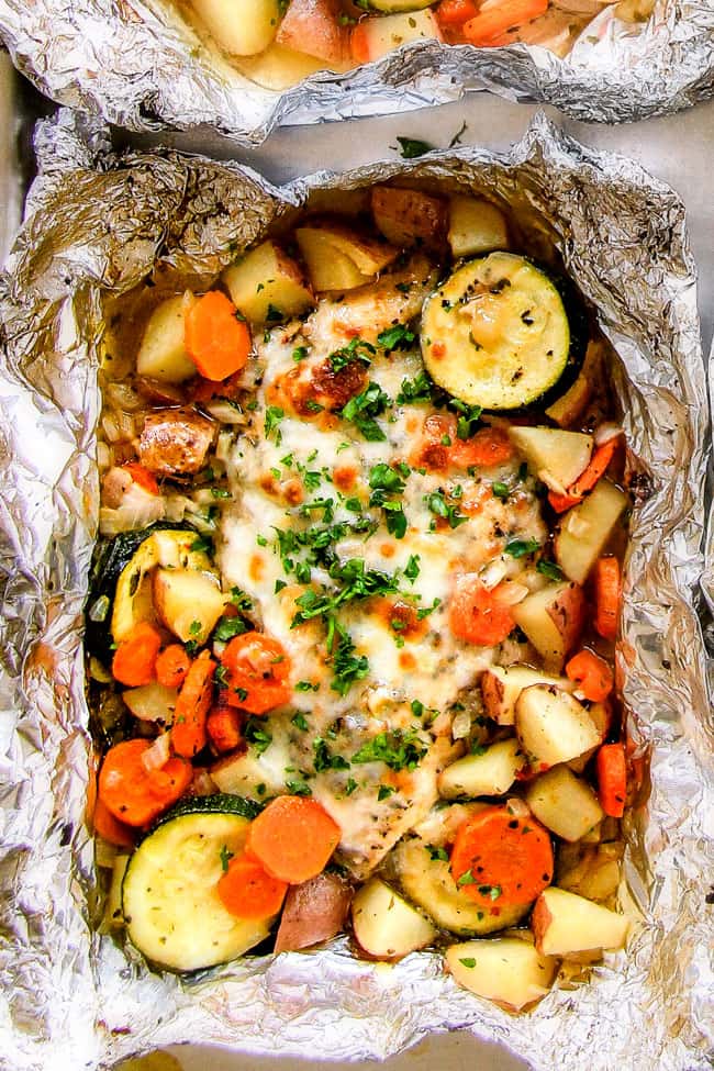 Baked or Grilled Italian Mozzarella Chicken Foil Packets are bursting with astonishingly juicy, flavorful chicken and tender, seasoned Potatoes, Carrots and Zucchini all smothered with Mozzarella Cheese! These foil packets are meal-in-one that are quick to throw together and even quicker to clean up!