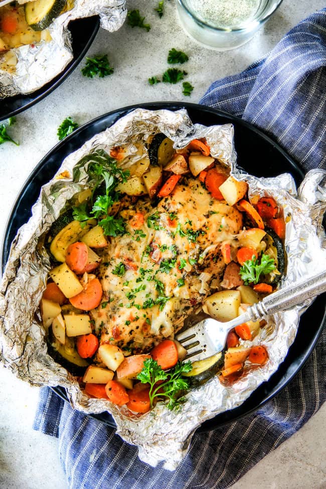 Baked or Grilled Italian Mozzarella Chicken Foil Packets are bursting with astonishingly juicy, flavorful chicken and tender, seasoned Potatoes, Carrots and Zucchini all smothered with Mozzarella Cheese! These foil packets are meal-in-one that are quick to throw together and even quicker to clean up!