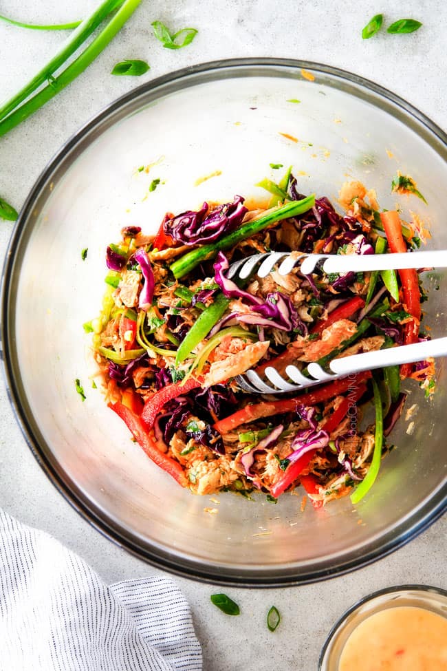 Showing how to make Chinese Chicken Salad Wraps mixing ingredients in a bowl.
