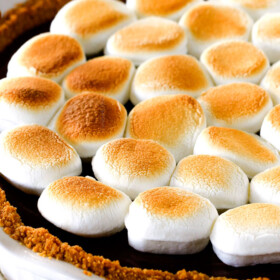 Make ahead Almost No Bake Nutella S'mores Pie is decadantly rich and creamy topped with golden marshmallows and SO EASY! I made this for a dinner party and everyone wanted the recipe!
