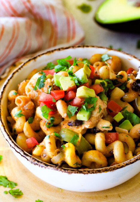 Lighter ONE POT Chicken Fajita Pasta has only minutes of hands-on cooking time!  Its smothered in cheesy, creamy salsa infused sauce bursting with your favorite fajita spiced chicken, onions and peppers!   The pasta cooks right IN the sauce for simple prep, minimal cleanup, and extra flavooooor!  