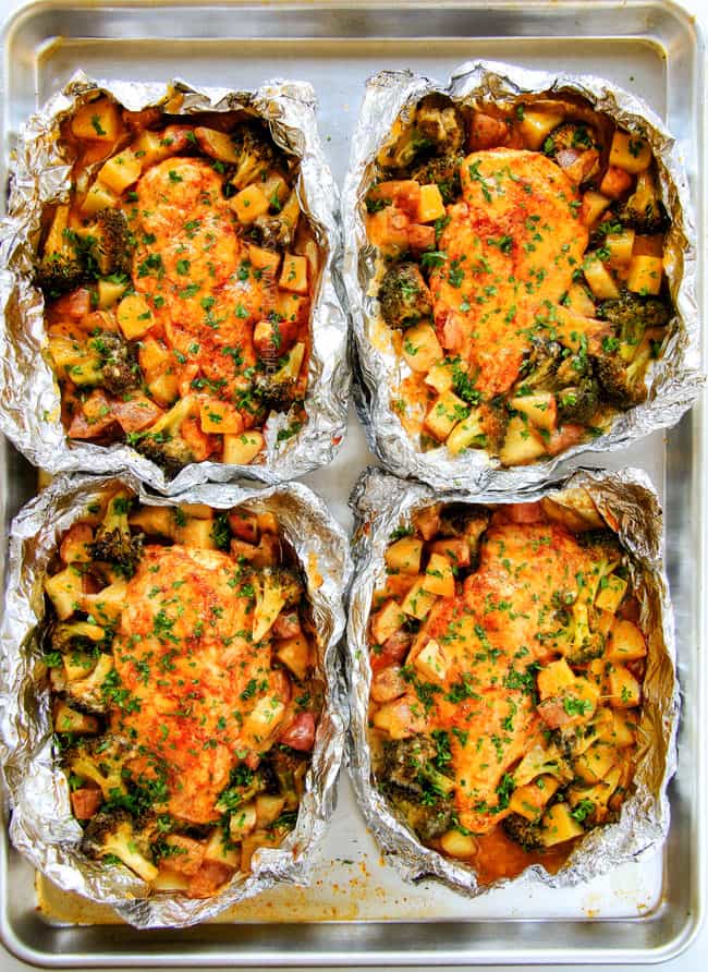 EASY Baked or Grilled Cheesy Buffalo Chicken Foil Packets bursting with juicy chicken and tender, flavorful veggies all smothered in cheddar and dipped in Ranch Crema! these are SO addictingly delicious!!!