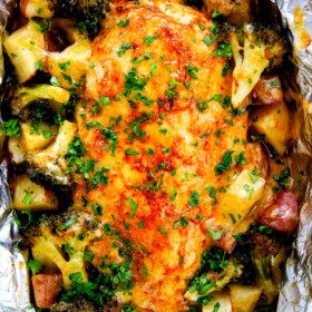 EASY Baked or Grilled Cheesy Buffalo Chicken Foil Packets bursting with juicy chicken and tender, flavorful veggies all smothered in cheddar and dipped in Ranch Crema! these are SO addictingly delicious!!!