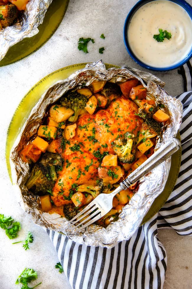 EASY Baked or Grilled Cheesy Buffalo Chicken Foil Packets bursting with juicy chicken and tender, flavorful veggies all smothered in cheddar and dipped in Ranch Crema! these are SO addictingly delicious!!!