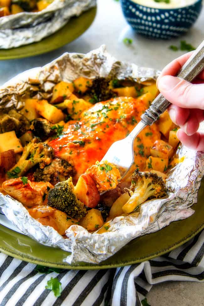 EASY Baked or Grilled Cheesy Buffalo Chicken Foil Packets bursting with juicy chicken and tender, flavorful veggies all smothered in cheddar and dipped in Ranch Crema! these are SO addictingly delicious!!!