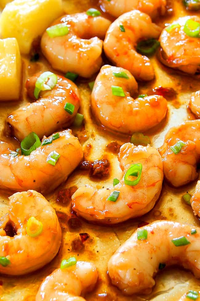 I am in love with this Sheet Pan Teriyaki Shrimp, Pineapple and Snap Peas! Its SO easy, healthy, a meal-in-one and the homemade Teriyaki sauce is the best I've ever had (DON'T be tempted to use store bought!)! I'm always keeping frozen shrimp on hand so I can make this any time! up close of the best teriyaki shrimp glazed in homemade teriyaki sauce