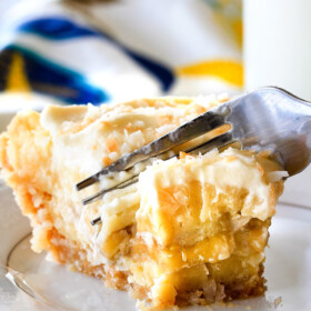 This Banana Coconut Cream Pie is absolutely AMAZING! Its the best ever banana pie and coconut cream pie mashed together nestled in an easy, Vanilla Wafer Coconut Crust and topped with COCONUT whipped cream! #thanksgiving #easter