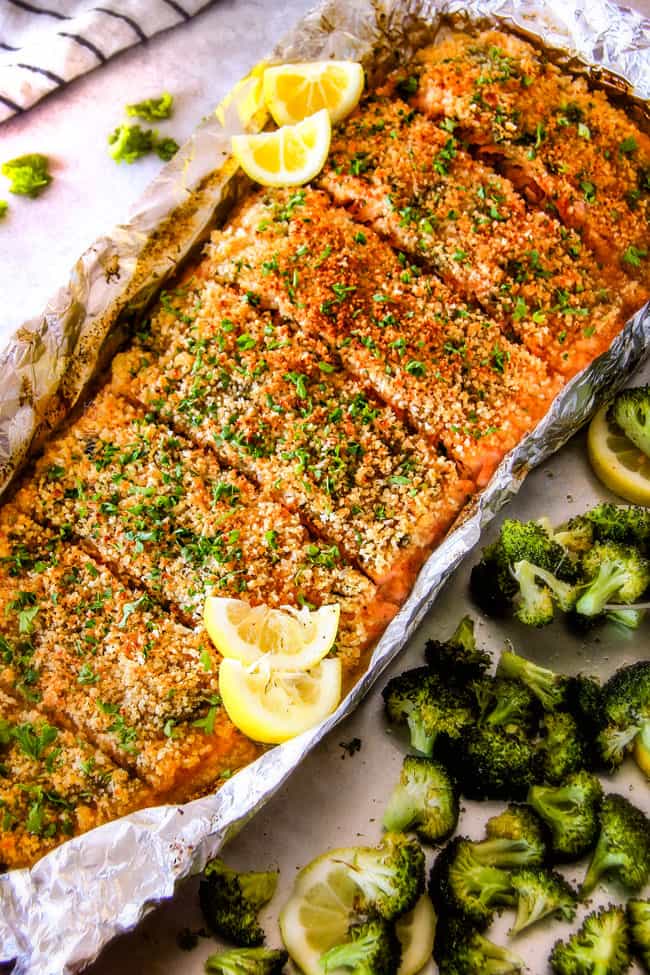 25 MINUTE Baked Lemon Garlic Butter Salmon with Crispy Parmesan Panko & Broccoli! This salmon is not only bursting with flavor and sooo juicy and tender but the easiest, most satisfying meal that tastes totally gourmet! My parents were blown away by this meal! healthy baked salmon recipe in foil with lemons on the side