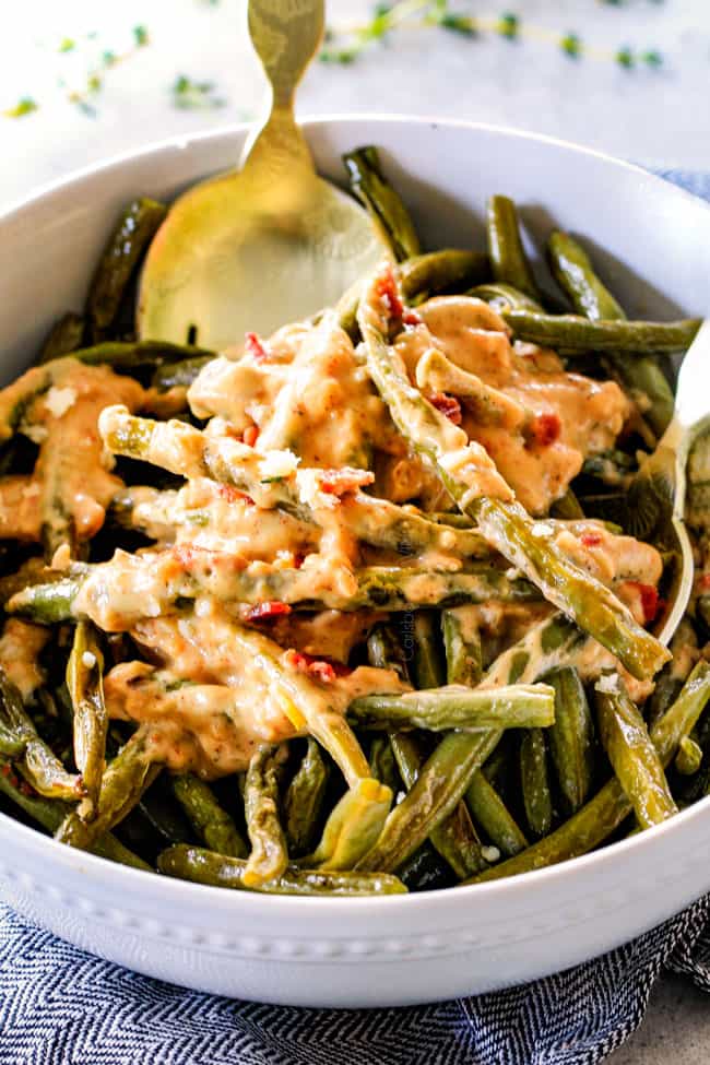 Forget green bean casserole, these wonderfully flavorful, crisp tender Roasted Green Beans with Creamy Gruyere Sauce are AMAZING!!! They the best green beans you will ever eat! They are easy enough for every day but delicious enough for special occasions (like Thanksgiving, Christmas!)! up close of the best oven roasted green beans in a white bowl
