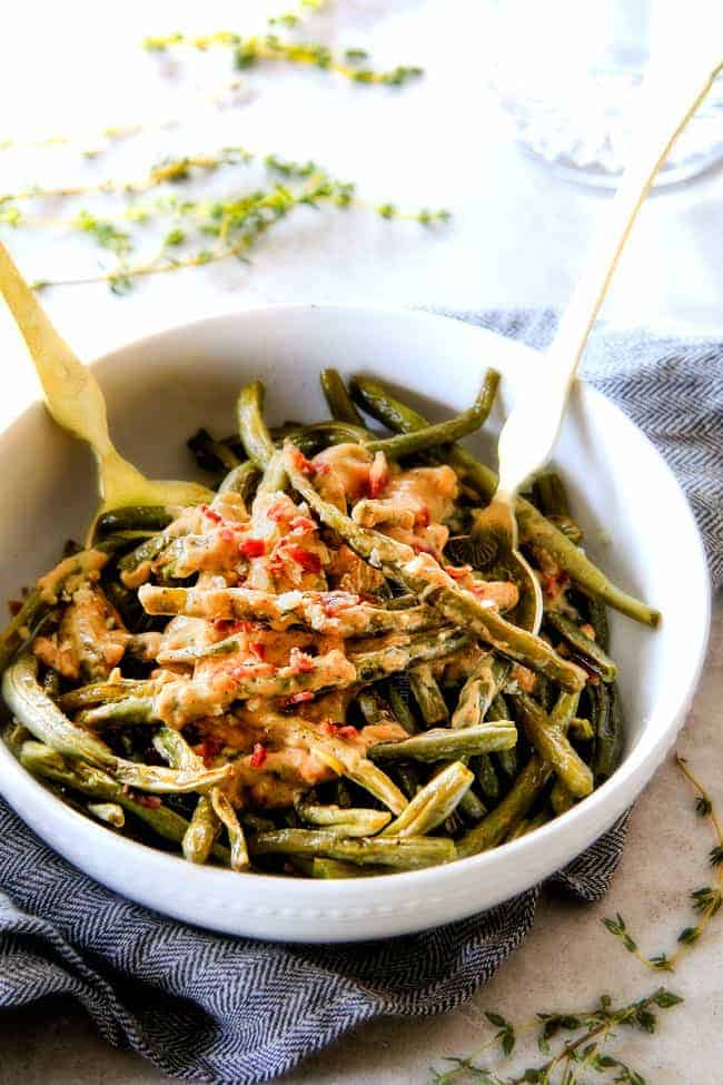 Forget green bean casserole, these wonderfully flavorful, crisp tender Roasted Green Beans with Creamy Gruyere Sauce are AMAZING!!! They the best green beans you will ever eat! They are easy enough for every day but delicious enough for special occasions (like Thanksgiving, Christmas!)! #greenbeancasserole #thanksgivingrecipe Baked Green Beans in a white bowl