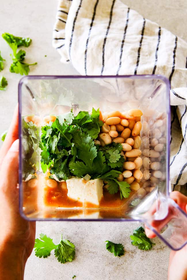 Showing how to make Crockpot Creamy White Chicken Chili blending ingredients.
