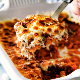 The best ever Sweet Potato Casserole with Marshmallows AND buttery, brown sugar Pecan Topping! This Sweet Potato Casserole has been our favorite recipe ever since we tasted it almost a decade ago and you will love that you can assemble it the night before Thanksgiving or Christmas! No Thanksgiving table is complete without this comforting classic!