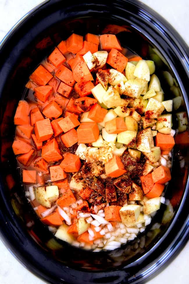 this SUPER creamy Slow Cooker Chipotle Sweet Potato Soup is AMAZING! Its loaded with flavor, gluten free, dairy free, crazy healthy and so easy! Definitely one of my new favorite soups! showing how to make Sweet Potato Soup by adding sweet potatoes, onions, garlic and apples to pot