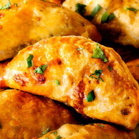 Freezer friendly, juicy, cheesy, shortcut Chipotle Chicken Empanadas doused in refreshingly Avocado Dip make the BEST crowd pleasing appetizers, dinners or snacks and can be made ahead of time and frozen for later! The filling is to die for and the store bought puff pastry dough makes an easy shortcut for the buttery, flaky golden pastry!