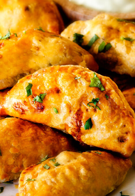 Freezer friendly, juicy, cheesy, shortcut Chipotle Chicken Empanadas doused in refreshingly Avocado Dip make the BEST crowd pleasing appetizers, dinners or snacks and can be made ahead of time and frozen for later! The filling is to die for and the store bought puff pastry dough makes an easy shortcut for the buttery, flaky golden pastry!