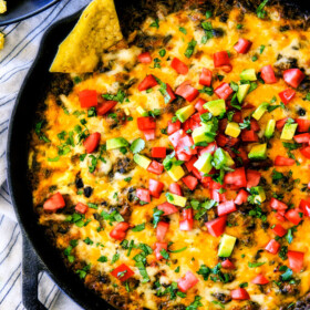 This warm, creamy, cheesy Mexican Spinach Dip is easy, make ahead, bursting with fiestalicious spices and quite possibly the BEST Spinach Dip ever AKA your new back pocket crowd pleasing appetizer for every occasion!