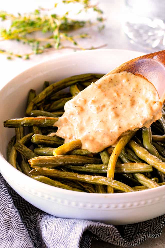 Forget green bean casserole, these wonderfully flavorful, crisp tender Roasted Green Beans with Creamy Gruyere Sauce are AMAZING!!! They the best green beans you will ever eat! They are easy enough for every day but delicious enough for special occasions (like Thanksgiving, Christmas!)! showing how to make roasted green beans by adding cheese sauce