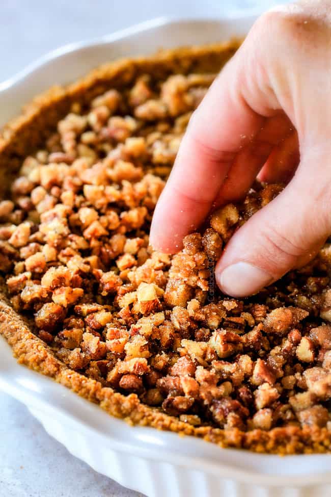 Adding topping to Prailine Pumpkin Pie.