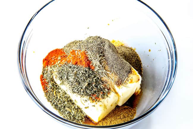 Roast Turkey with Herb Butter by melting butter and herbs in a clear bowl.